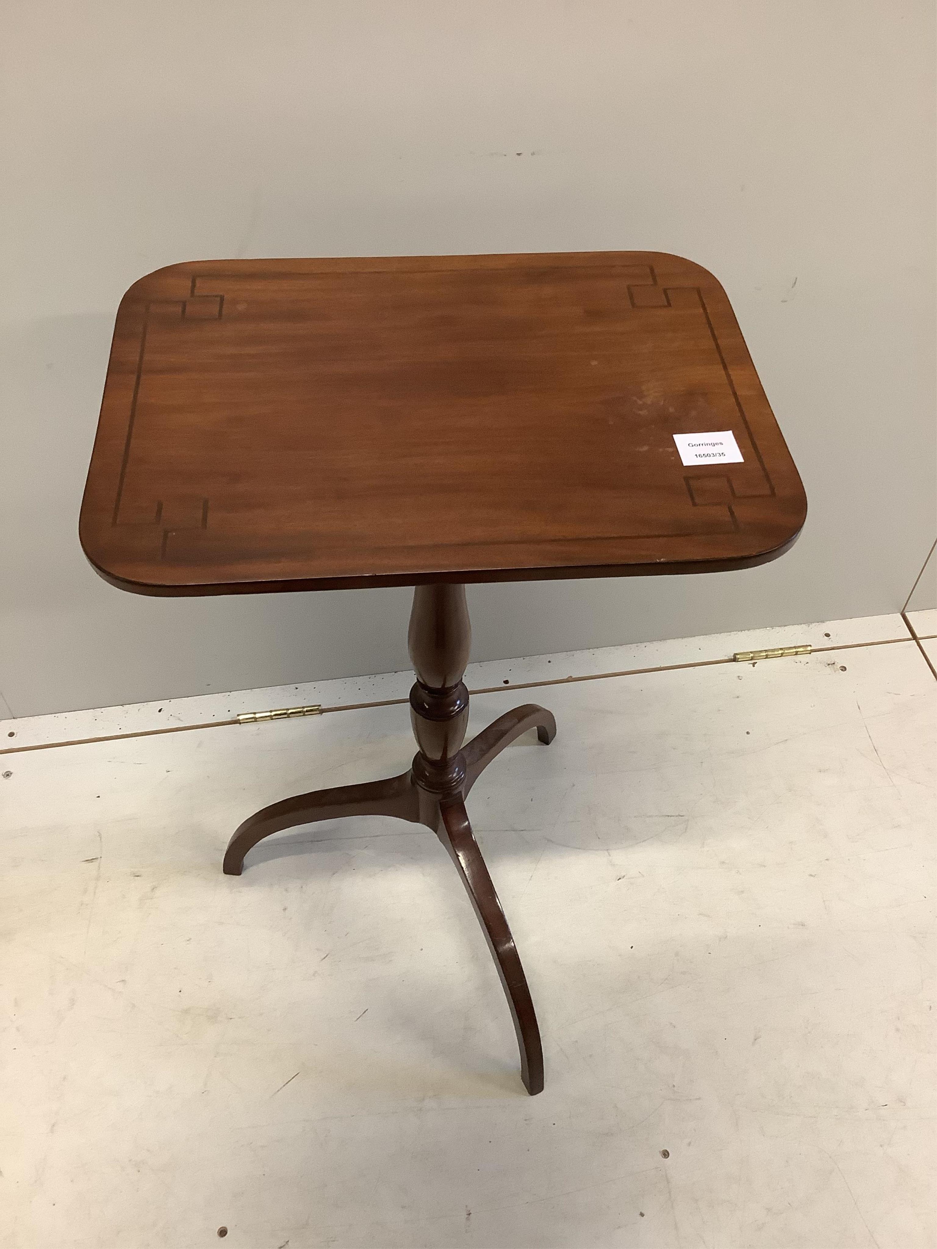 A Regency ebony strung mahogany tripod wine table on downswept legs, width 45cm, depth 33cm, height 72cm. Condition - fair, top marked and warped slightly.